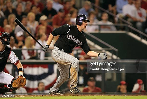 Brad Hawpe of the Colorado Rockies hits a 2-RBI single in the top of the third inning against the Arizona Diamondbacks during Game One of the...