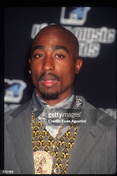 Singer Tupac Shakur stands backstage at the MTV Video Music Awards September 4, 1996 in New York City. The awards honored music videos produced by...