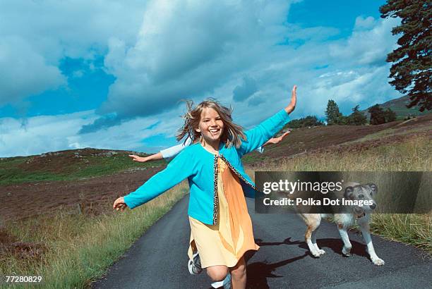 girls running with dog on rural road - curvy white girl photos et images de collection