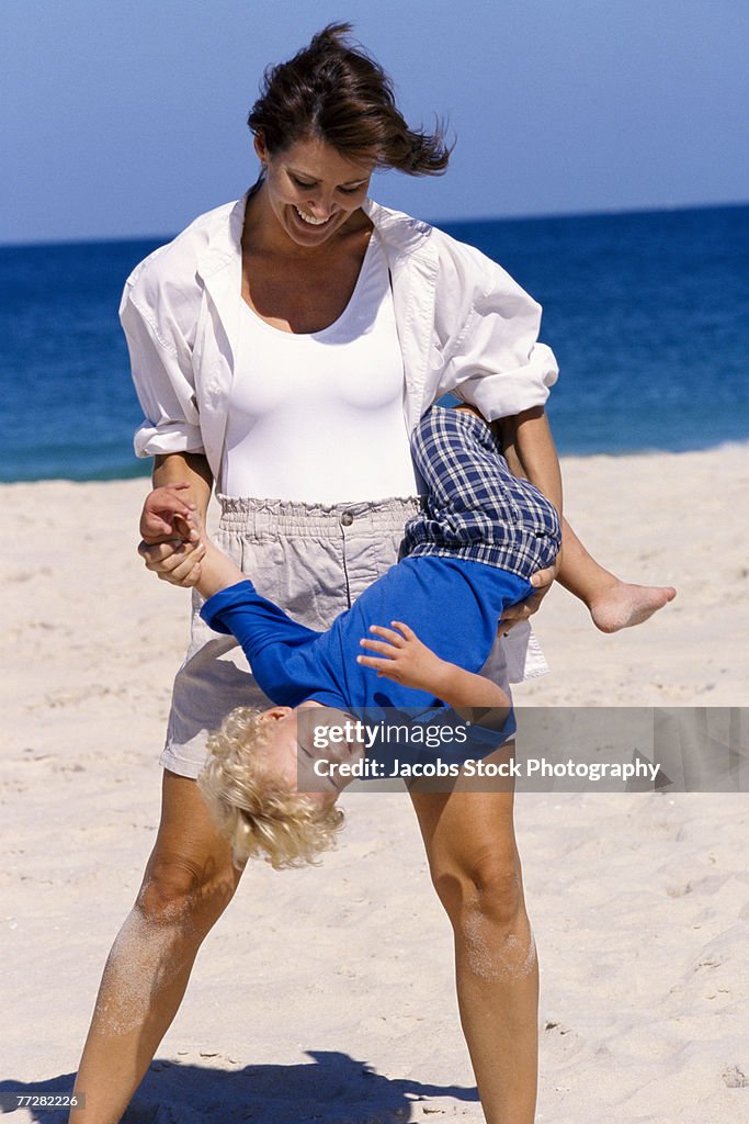 Mother holding her son on the beach