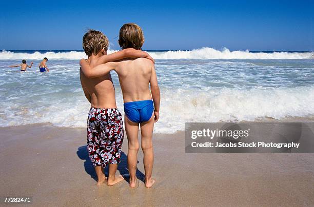 Two Boys At The Beach High-Res Stock Photo - Getty Images