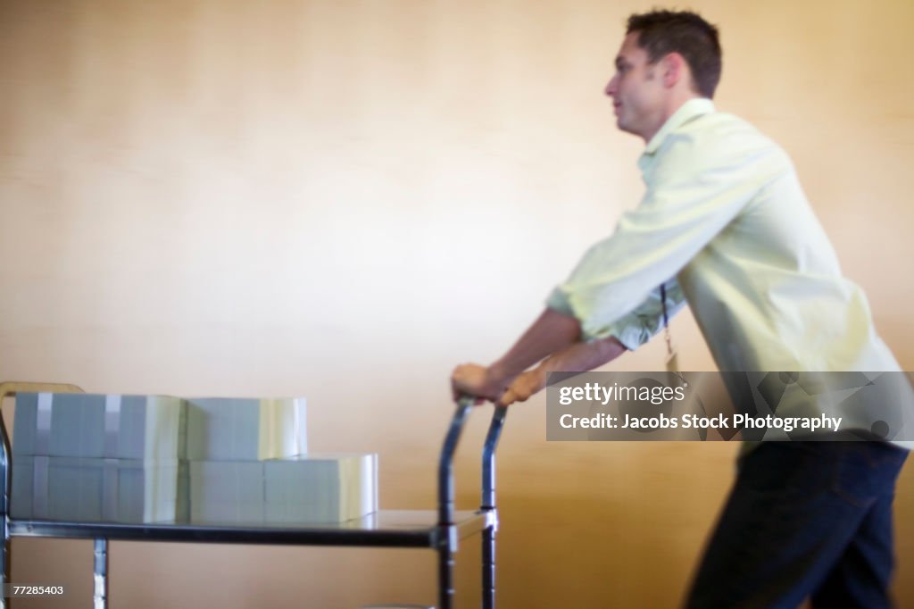 Businessman pushing cart