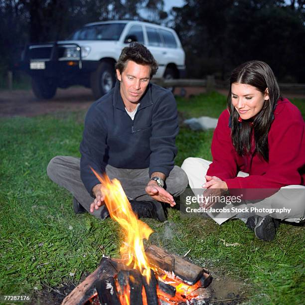 couple warming up at campsite - car warming up stock pictures, royalty-free photos & images