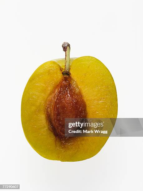 sliced greengage with pit - greengage stock pictures, royalty-free photos & images