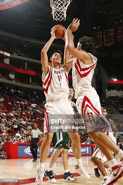 Yao Ming of the Houston Rockets and Luis Scola of the Houston Rockets go up for a rebound against Euroleague champion Panathinaikos October 11, 2007...