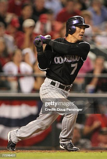 Kazuo Matsui of the Colorado Rockies drives home Yorvit Torrealba as Matsui reached first on an error by Conor Jackson of the Arizona Diamondbacks...