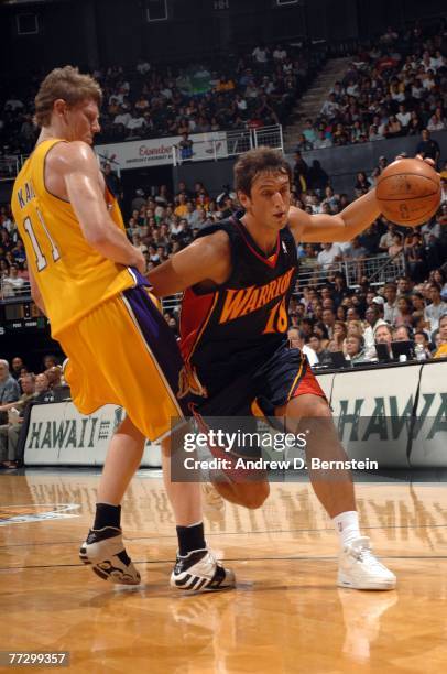 Marco Belinelli of the Golden State Warriors drives past Coby Karl of the Los Angeles Lakers at the Stan Sheriff Center on October 11, 2007 in...