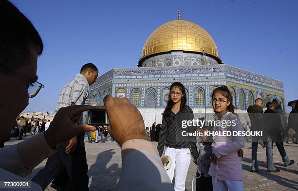 Father takes a photgrapher of his children in front of the Dome of the Rock in the al-Aqsa Mosque compound, Islam's third holiest site, following...