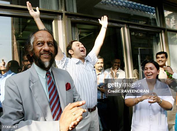Chairman of the Intergovernmental Panel on Climate Change Rajendra Pachauri celebrates with students and office staff after winning the Nobel Peace...