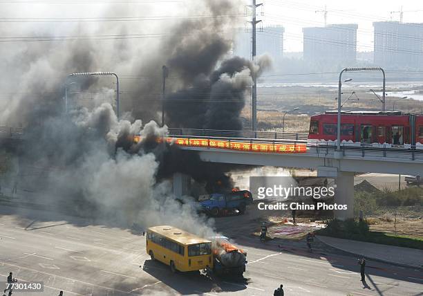 Fuel tanker catches fire beside a coach in a simulated crash during a public emergency drill held by emergency services at Yitonghe Metro Railway...