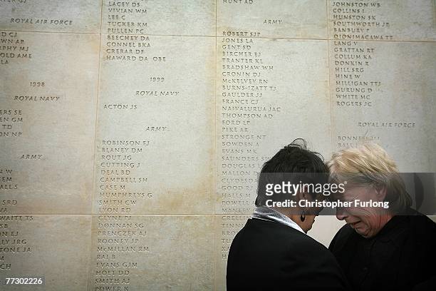 Mothers Theresa Evans and Anne Lawrence meet for the first time and console each other after finding the names of their sons inscribed on the wall of...