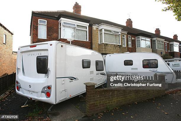 Caravans are parked outside flood damaged homes on October 11, 2007 in Hull, England. Pensioners Terry and Mary Cole, both aged 87, have been living...
