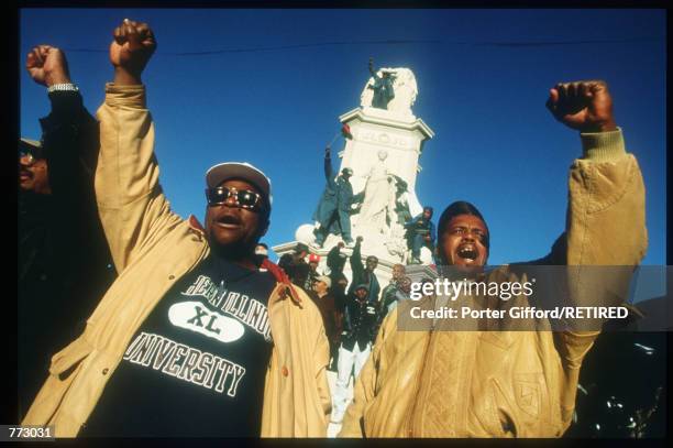 Marchers raise their fists at the Million Man March October 16, 1995 in Washington, DC. The purpose of the march was to galvanize men to respect...