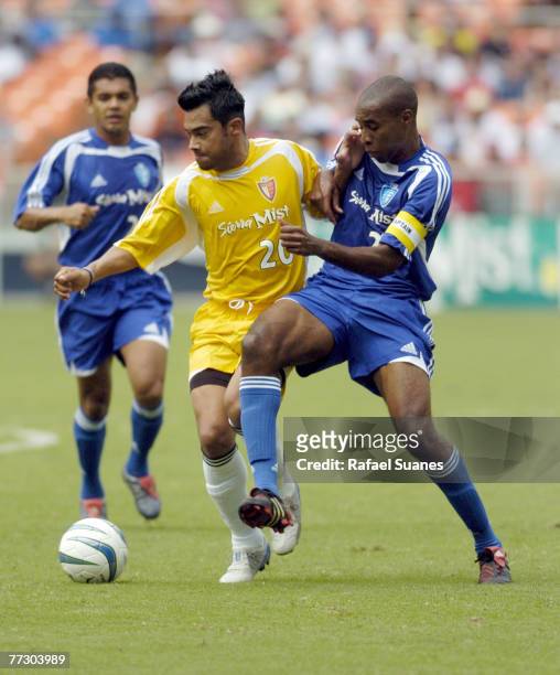 Eastern Conference captain Eddie Pope tries to remove Carlos Ruiz from the ball at RFK Stadium on July 31, 2004. The Eastern Conference defeated the...