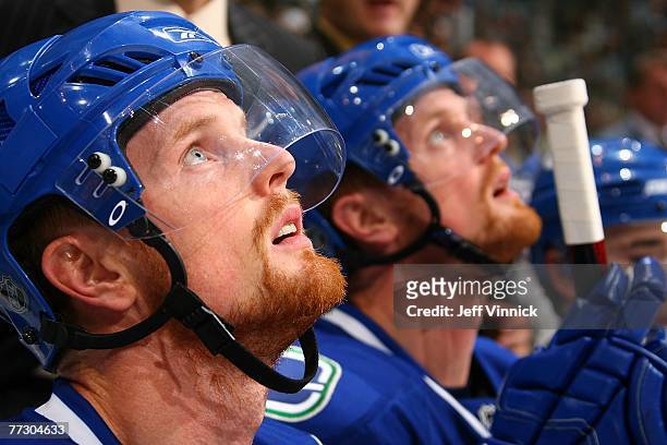 Daniel Sedin and Henrik Sedin of the Vancouver Canucks watch from the bench during their game against the Philadelphia Flyers at General Motors Place...
