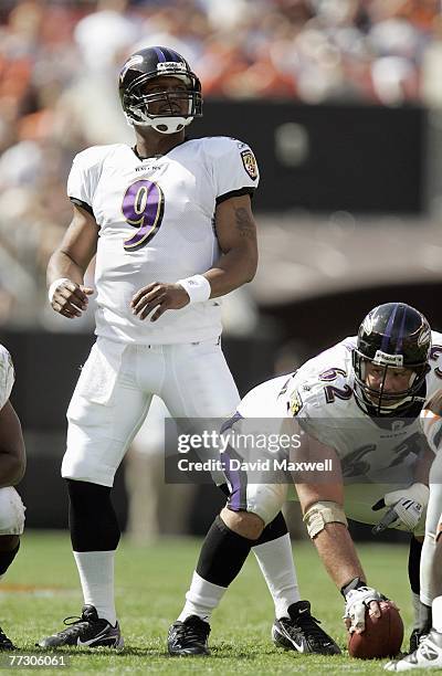 Quarterback Steve McNair of the Baltimore Ravens looks down the field as center Mike Flynn gets ready on the line during the NFL game against the...
