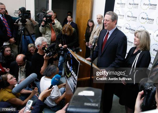 Former U.S. Vice president Al Gore speaks to reporters as his wife Tipper Gore looks on during a news conference discussing his Nobel Peace Prize win...