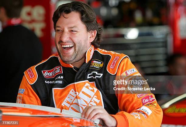 Tony Stewart, driver of the The Home Depot Chevrolet, gets into his car in the garage during practice for the NASCAR Nextel Cup Series Bank of...