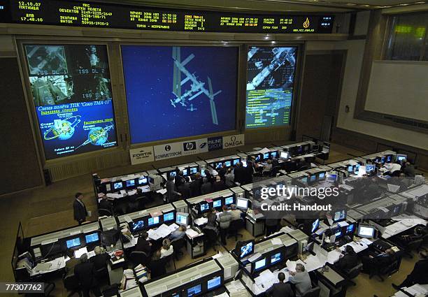 Live video from the Soyuz TMA-11 spacecraft of the International Space Station is shown on the screen at the Russian Mission Control Center October...