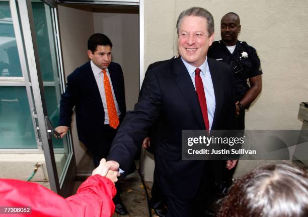 Former U.S. Vice president Al Gore greets supporters as he leaves the offices of Alliance for Climate Protection after speaking to reporters during a...