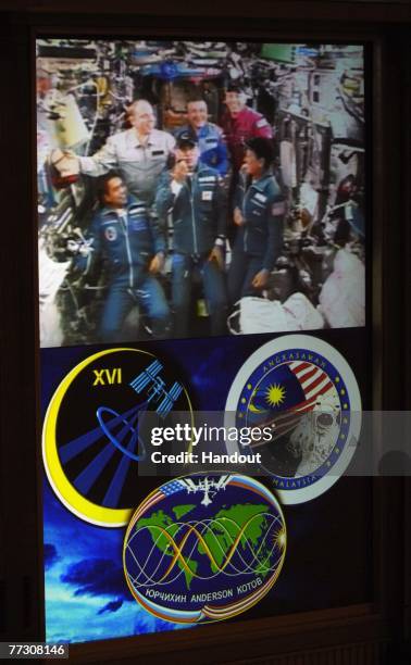 Live video from the Soyuz TMA-11 spacecraft of the International Space Station is shown on the screen at the Russian Mission Control Center October...