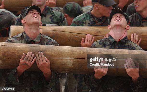 Basic Underwater Demolition/SEAL students participate in Log PT during Hell Week June 22, 2003 in Coronado, California. Log PT is a demonstration not...