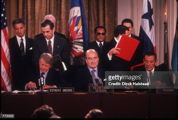 President Carter and Panamanian leader General Omar Torrijos Herrera sign at the OAS Headquarters September 7, 1977 in Washington, D.C. The two new...