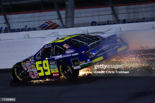 Marcos Ambrose, driver of the Kingsford Charcoal/Bush's Baked Beans Ford, crashes into the wall during the NASCAR Busch Series Dollar General 300 at...