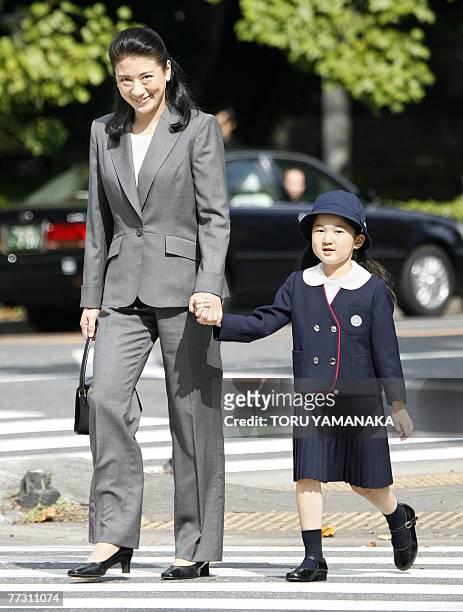 Japanese Crown Princess Masako walks with her daughter Princess Aiko hand in hand as they head for Gakushuin Elementary School to watch the annual...