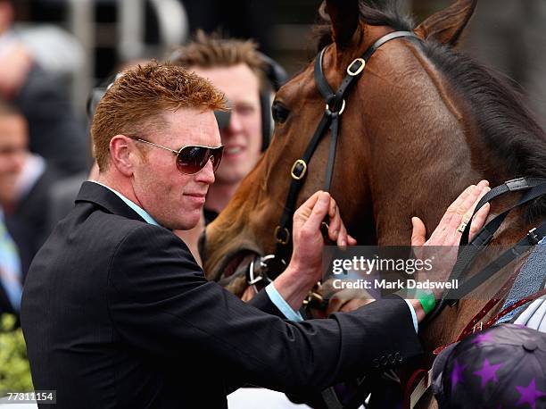 Trainer of Green Mankini John White from Mornington pats his horse after winning Race One the Harrolds Fashion Plate during the Caulfield Guineas Day...