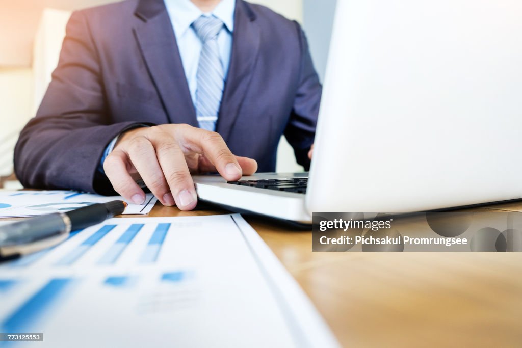 Midsection Of Businessman Using Laptop