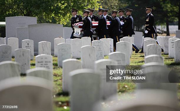 Soldiers from the US 3rd Infantry, traditionally known as the Old Guard, carry the remains of 12 US army soliders, killed when their UH-60 Black Hawk...