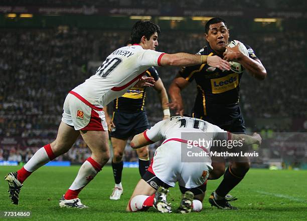 Lee Gilmour and Chris Flannery of St.Helens tackle Ali Lauitiiti of Leeds during the engage Super League Grand Final match between St.Helens and...