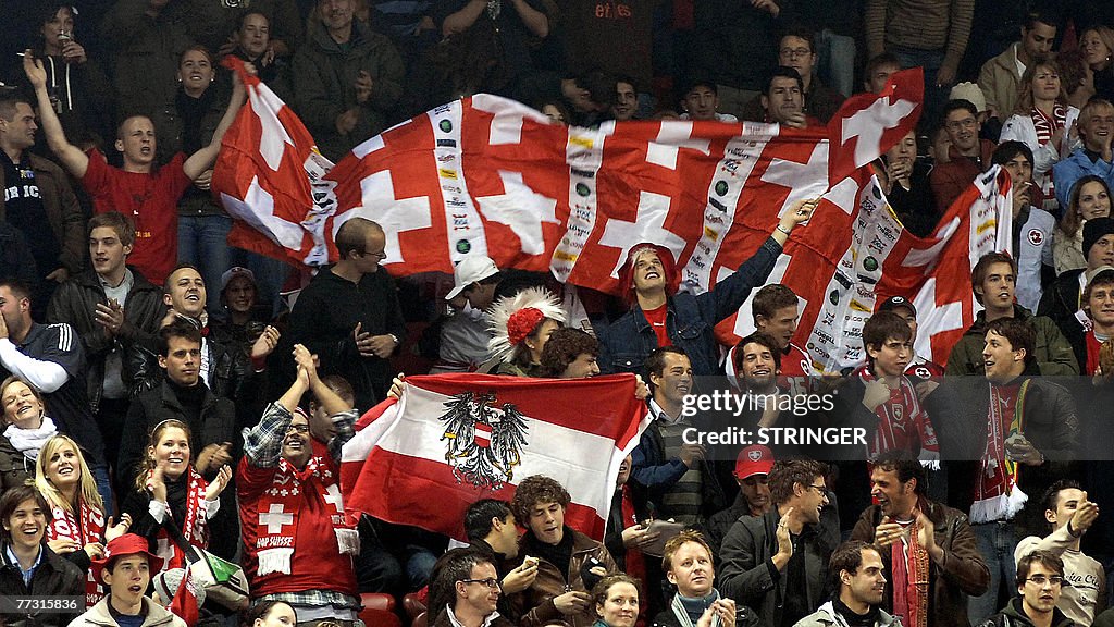 Swiss and Austrian supporters cheer duri
