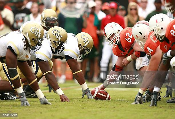 Center John Rochford of the Miami Hurricanes looks up before snapping the ball while taking on the Georgia Tech Yellow Jackets at the Orange Bowl on...