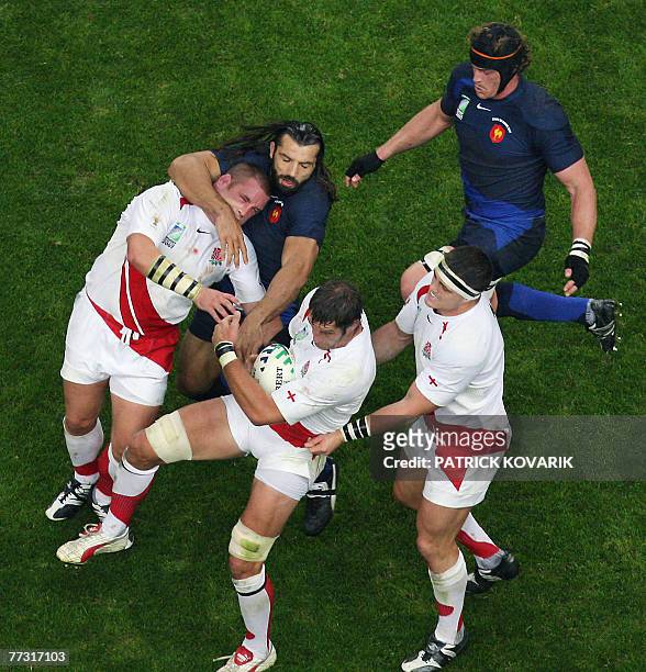 England's lock Simon Shaw holds the ball assisted by England's prop and captain Phil Vickery and England's prop Andrew Sheridan as France's lock...