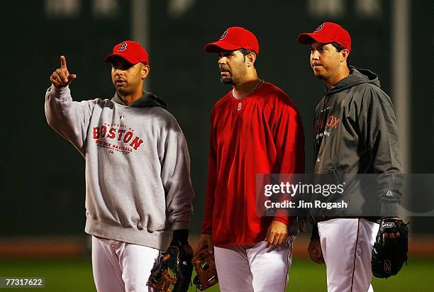 Alex Cora, Mike Lowell and Josh Beckett of the Boston Red Sox warm up before Game Two of the American League Championship Series against the...