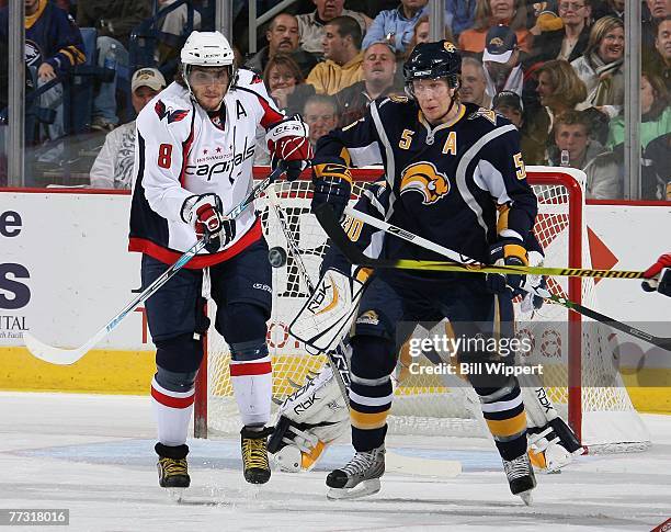 Toni Lydman of the Buffalo Sabres battles for the puck with Alex Ovechkin of the Washington Capitals at HSBC Arena October 13, 2007 in Buffalo, New...