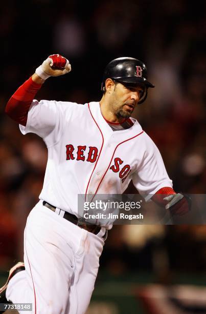 Mike Lowell of the Boston Red Sox celebrates his solo home run in the fifth inning during Game Two of the American League Championship Series against...
