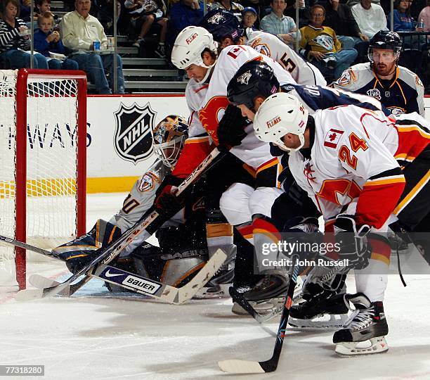 Adrian Aucoin of the Calgary Flames shoots the puck on Chris Mason of the Nashville Predators at the Sommett Center on October 13, 2007 in Nashville,...
