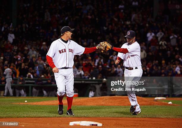 Mike Timlin of the Boston Red Sox congratulates Mike Lowell after ending the eighth inning of Game Two of the American League Championship Series...