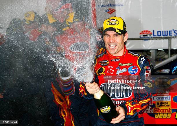 Jeff Gordon, driver of the DuPont Chevrolet, celebrates in victory lane after winning the NASCAR Nextel Cup Series Bank of America 500 at Lowe's...