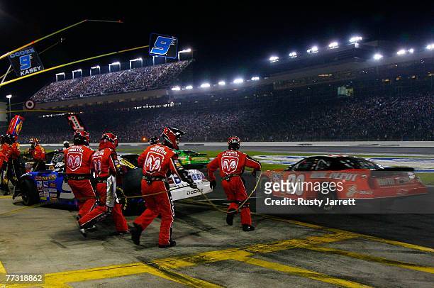 Kasey Kahne, driver of the Dodge Dealers/UAW Dodge, sits sideways in his pit stall after being spun by Tony Stewart, driver of the The Home Depot...