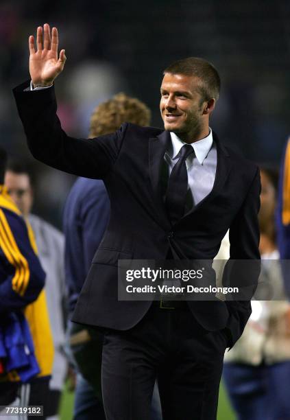 Injured Los Angeles Galaxy midfielder David Beckham waves to fans from the field after the Los Angeles Galaxy defeated Toronto FC 2-1 after their MLS...