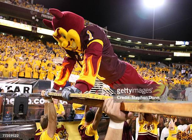 Sparky" the Arizona State Sun Devils mascot does pushups in front of the student section after a Sun Devils' touchdown against the Washington Huskies...