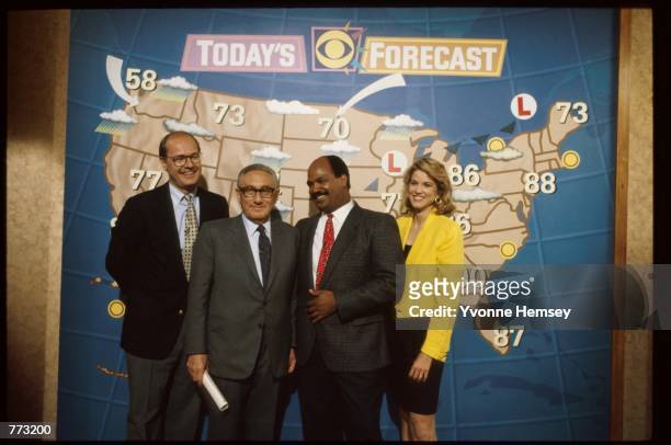 Henry Kissinger stands with anchor Harry Smith, weatherman Mark McEwen and anchor Paula Zahn on the "CBS This Morning" television news program May...