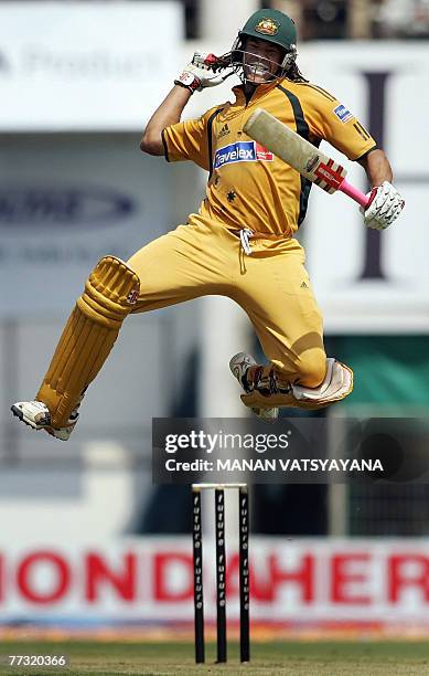 Australian cricketer Andrew Symonds leaps in air as he celebrates after scoring a century during the sixth One-day International match between India...