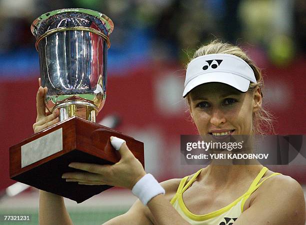 Russian Elena Demenmtieva holds a trophy as she celebrates her victory over Serena Williams of USA at the final of the Kremlin Cup women's tennis...