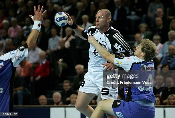 Henrik Lundstroem of Kiel fights for the ball with Felix Lobedank of Balingen during the Bundesliga Handball match between THW Kiel and HBW...