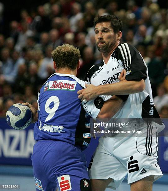 Stefan Loevgren of Kiel fights for the ball with Frank Ettwein of Balingen during the Bundesliga Handball match between THW Kiel and HBW...